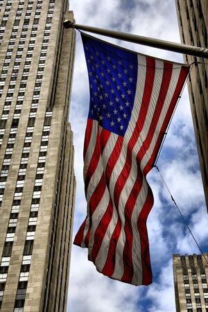 Image of US flag by Manhattan skyscraperの写真素材