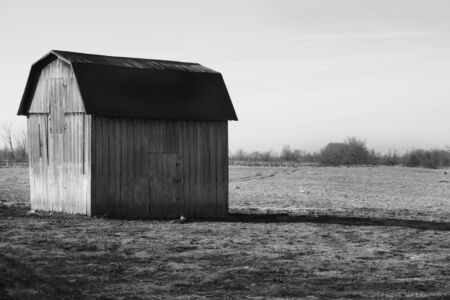 Abandoned wooden shed in fieldの写真素材