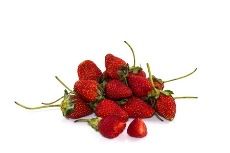 Strawberries, ripe red berries and a bite on white backgroundの写真素材