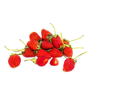 Strawberries, ripe red berries and a bite on white backgroundの写真素材