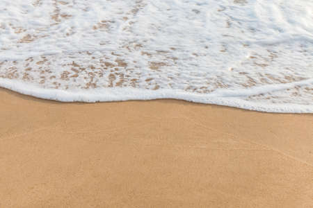 Closeup of sand and small wave  with lot of copy space for message backgroundの写真素材