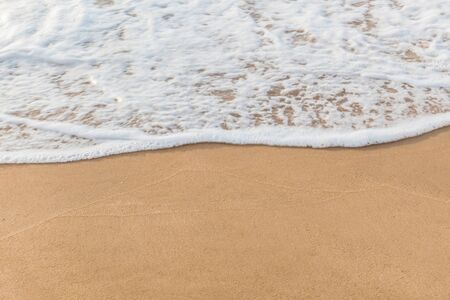 Closeup of sand and small wave  with lot of copy space for message backgroundの写真素材