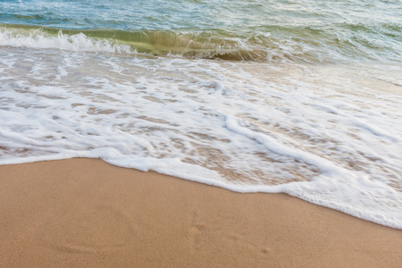 Wave of the sea on the sand beach for bacgroundの写真素材