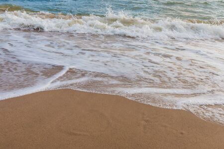 Wave of the sea on the sand beach for bacgroundの写真素材