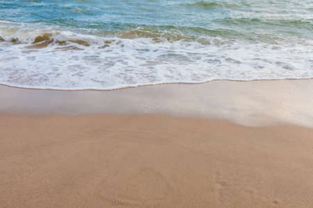 Wave of the sea on the sand beach for bacgroundの写真素材