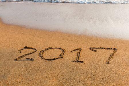 New Year 2017 is coming concept - write  2017 on a beach sandの写真素材