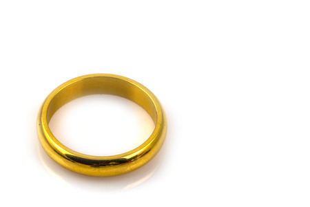 Golden wedding rings isolated on white backgroundの写真素材