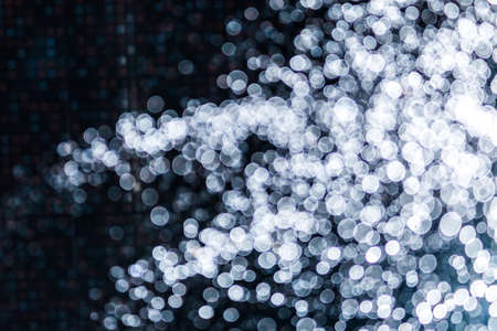 White bokeh of water and lights on black backgroundの写真素材