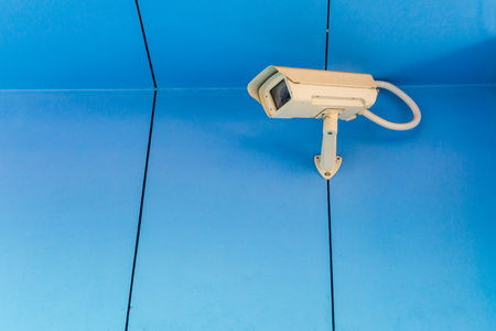 Security camera on the blue wall.の写真素材