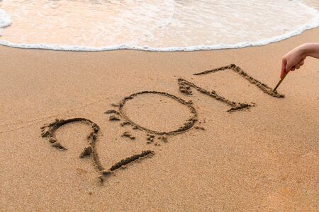 2017, a message written in the sand at the beach.