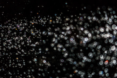 Black bokeh of water fly and lights on black backgroundの写真素材