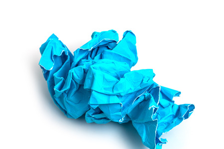 Crumpled blue paper a white backgroundの写真素材