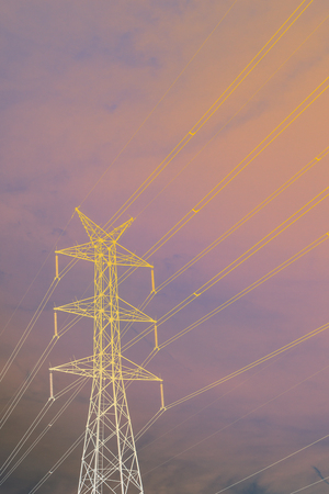 High voltage pole with a blue sky background.の写真素材