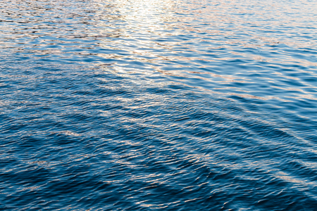 water wave surface with Sun light backgroundの写真素材