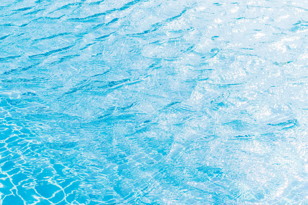 Hotel swimming pool blue with sunny reflections