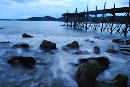 Wood bridge and waveの写真素材