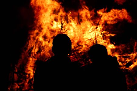 Silhouette of two boys at a fireplaceの写真素材