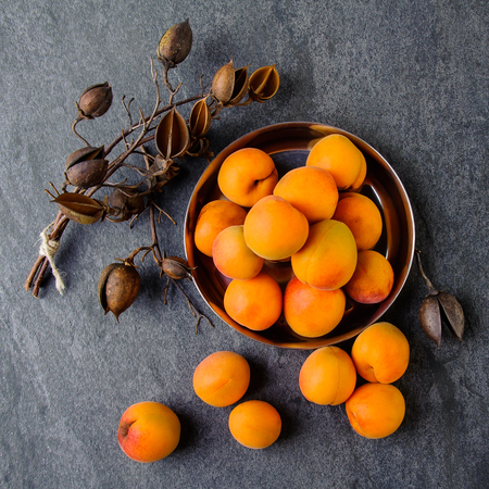 Apricots in a metal pial are stackedの写真素材