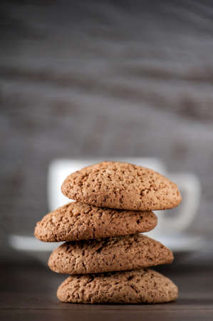cup of coffee with oatmeal cookies on a wooden table