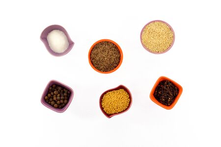 Various kinds of spices in tiny cups on a white backgroundの写真素材