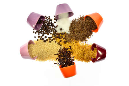 Seeds, spices, grains woken and mixed with each other on a white backgroundの写真素材