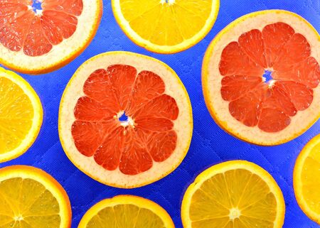The blue background of the different types of citrus orange, lemon, grapefruitの写真素材