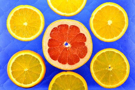 The blue background of the different types of citrus orange, lemon, grapefruitの写真素材