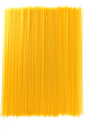 Long pasta lie on a white background in the form of carpetの写真素材