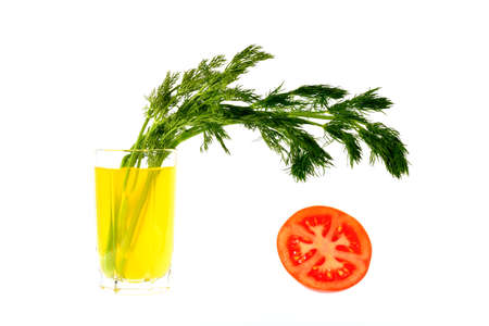 Lemon juice with a bunch of dill and half a tomato on a white backgroundの写真素材