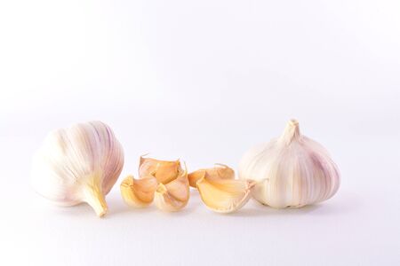 Two heads mature garlic cloves and a white backgroundの写真素材