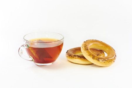 Bagels with poppy and tea on a white backgroundの写真素材