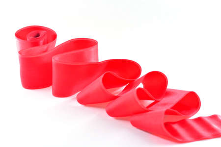 Red satin ribbon on a white backgroundの写真素材