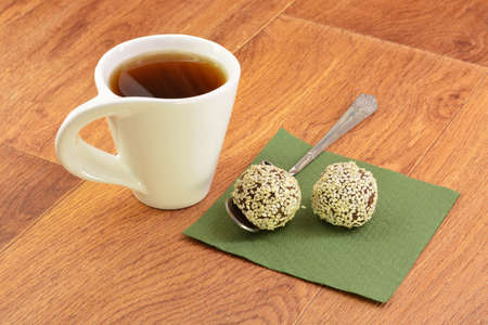Cake and tea on green napkin wooden backgroundの写真素材