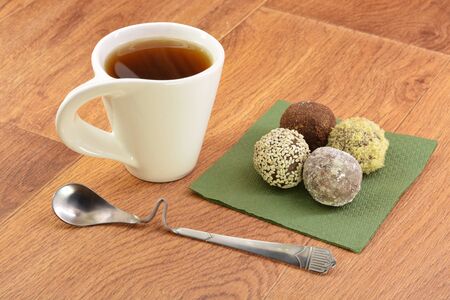 Cake and tea on green napkin wooden backgroundの写真素材