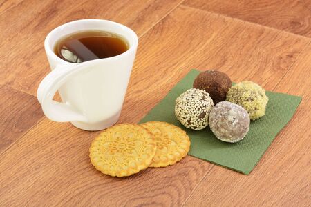 Cake and tea on green napkin wooden backgroundの写真素材