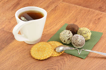 Cake and tea on green napkin wooden backgroundの写真素材