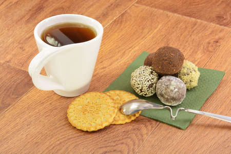 Cake and tea on green napkin wooden backgroundの写真素材