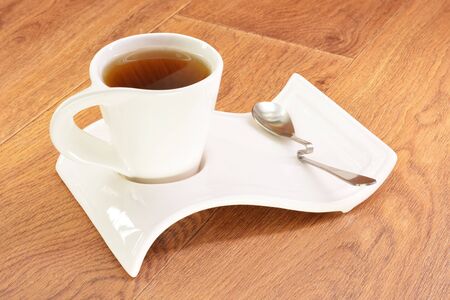 Black tea in a white circle on a wooden backgroundの写真素材