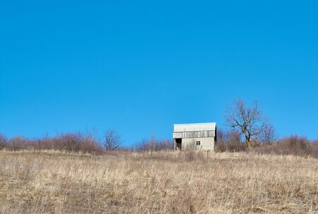 Abandoned piece of land and a house in the early springの写真素材
