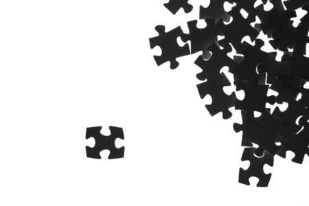 Black puzzle laid out on a white backgroundの写真素材