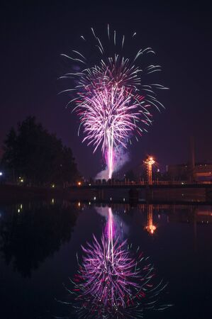 Fireworks in the city and reflection in the riverの写真素材