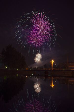 Fireworks in the city and reflection in the riverの写真素材