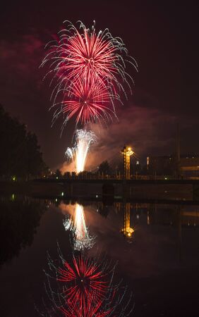 Fireworks in the city and reflection in the riverの写真素材