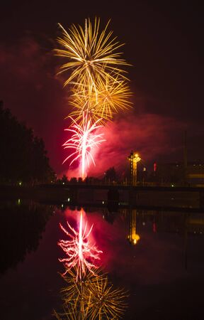 Fireworks in the city and reflection in the riverの写真素材