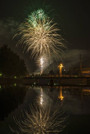 Fireworks in the city and reflection in the riverの写真素材
