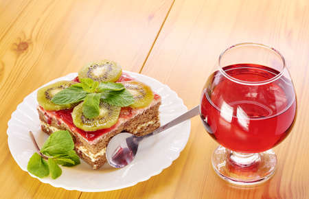 Glass of red wine and a dessert of kiwiの写真素材