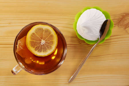 Black tea with lemon cake and marshmallowsの写真素材