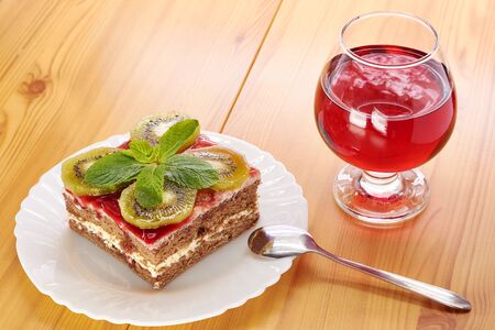 Glass of red wine and a dessert of kiwiの写真素材
