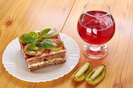 Glass of red wine and a dessert of kiwiの写真素材