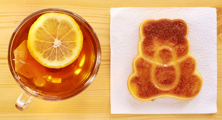 Black tea with lemon and cinnamon cupcake on a wooden tableの写真素材